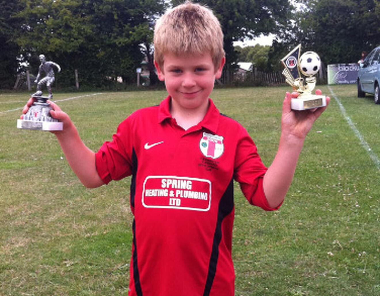 Dan with football trophies